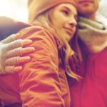 close up of happy couple hugging in autumn park